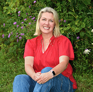 photo of Ellen Morse in red blouse in floral field