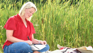 photo of Ellen Morse working on artwork in natural setting